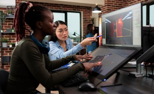 digital-interactive-entertainment-industry-workers-working-with-cgi-game-development-creative-agency-artists-conversating-about-level-design-3d-assets-while-sitting-office-workspace