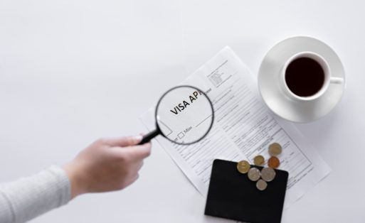 visa-application-form-documents-magnifier-cup-coffee-white-background-concept-immigration-registration-copy-space